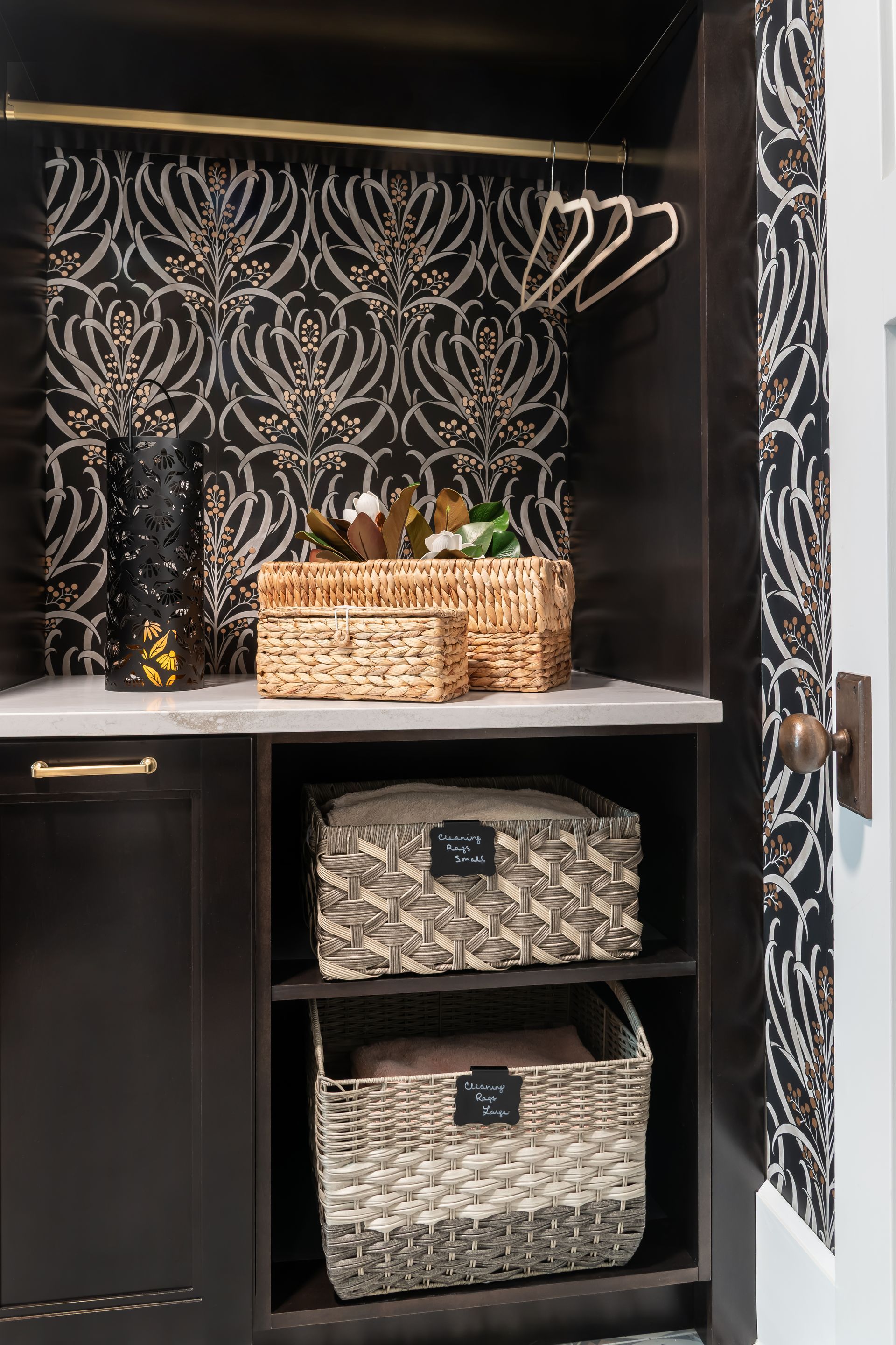 A laundry room with wicker baskets and clothes hangers.