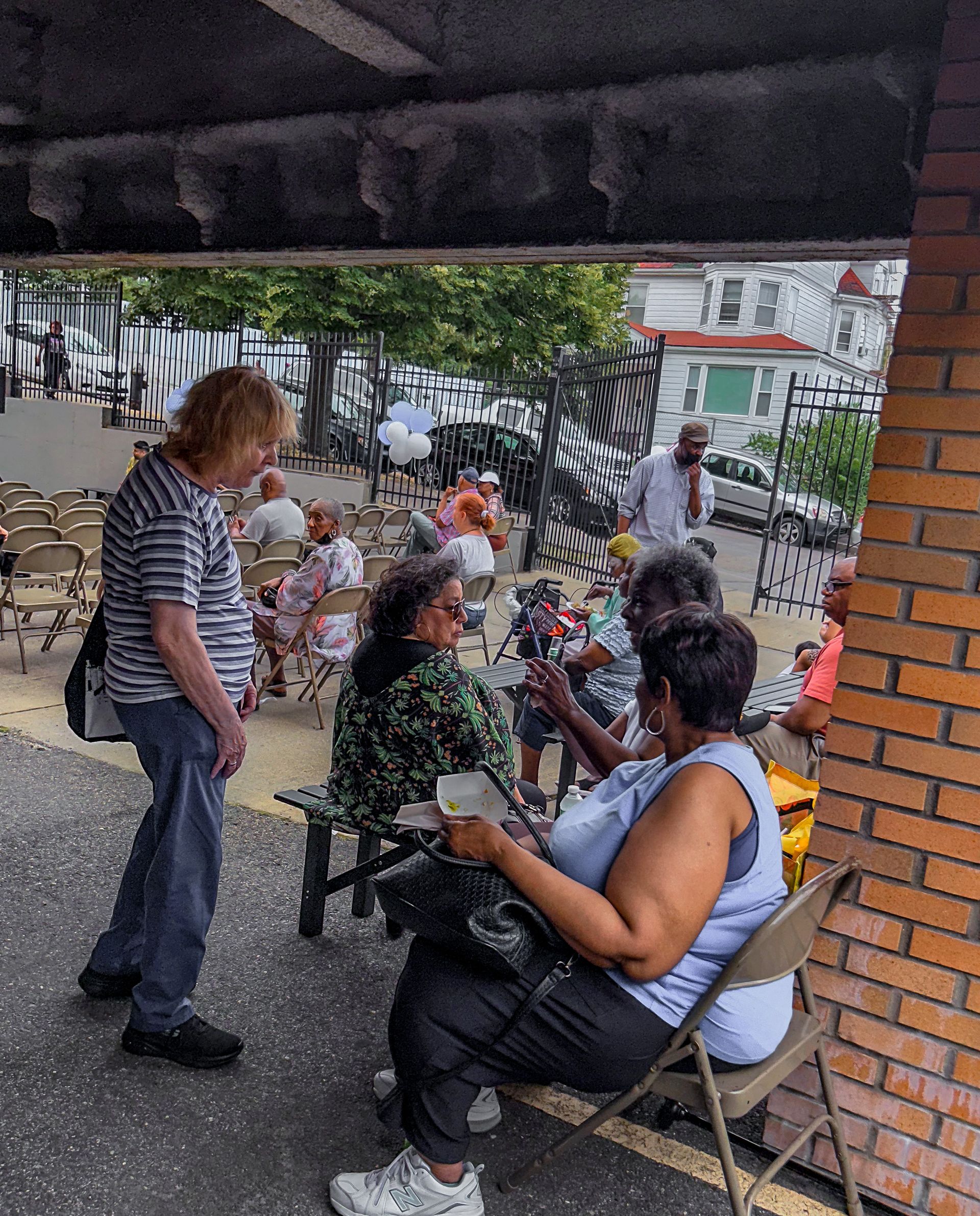 A group of people are sitting in chairs outside a building