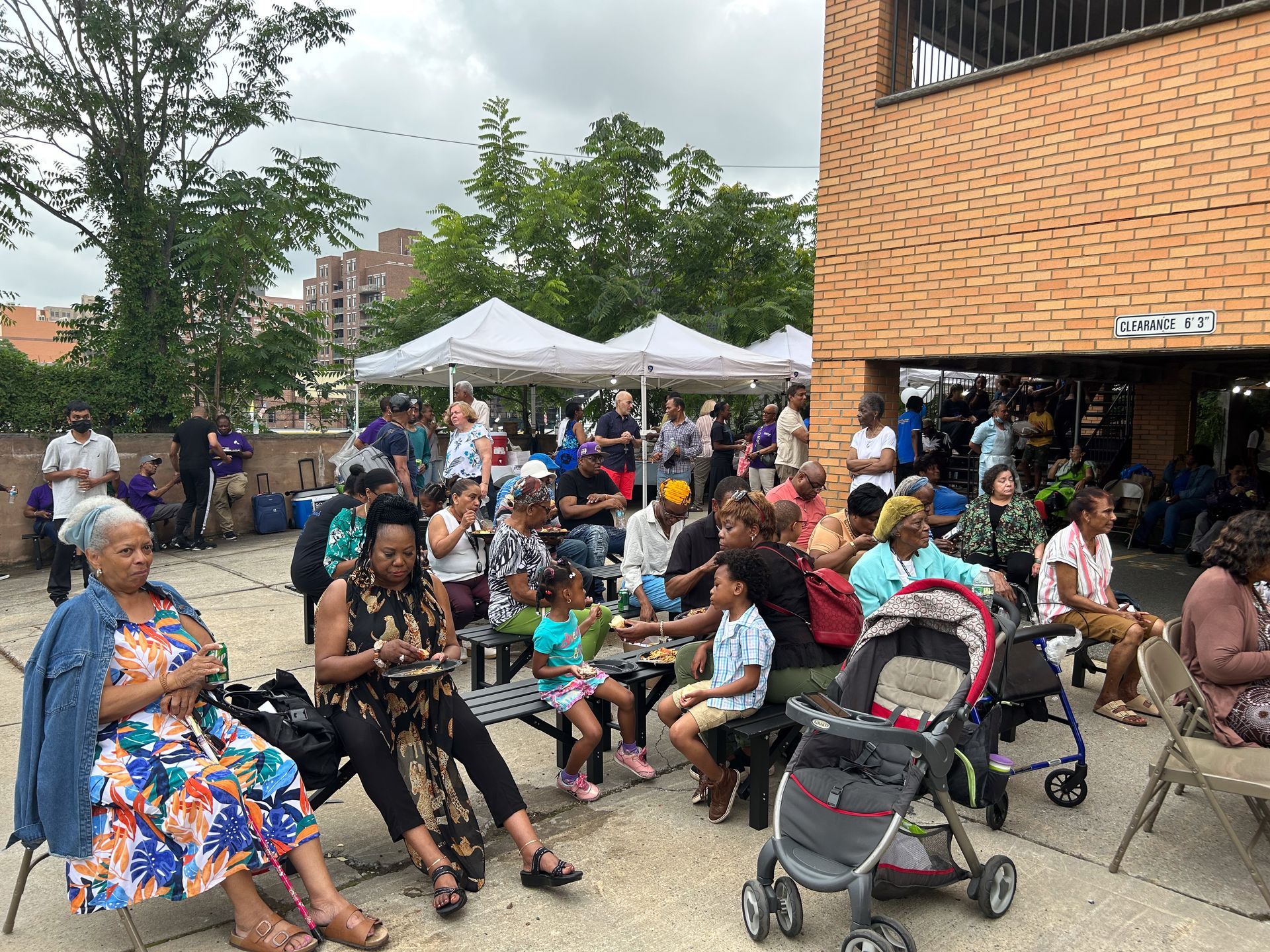 A large group of people are sitting outside of a building.