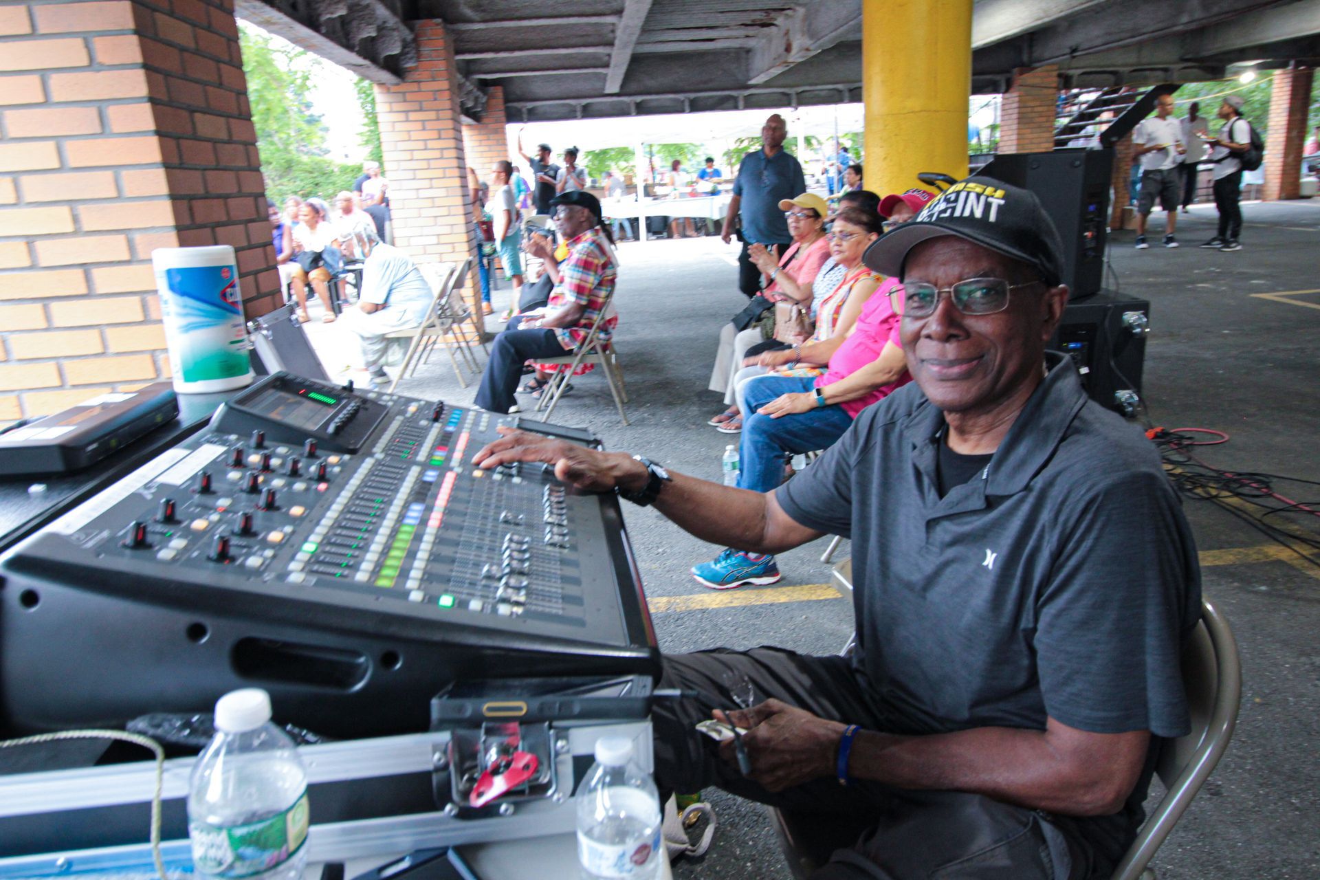 A man is sitting in front of a mixer that says denver on it