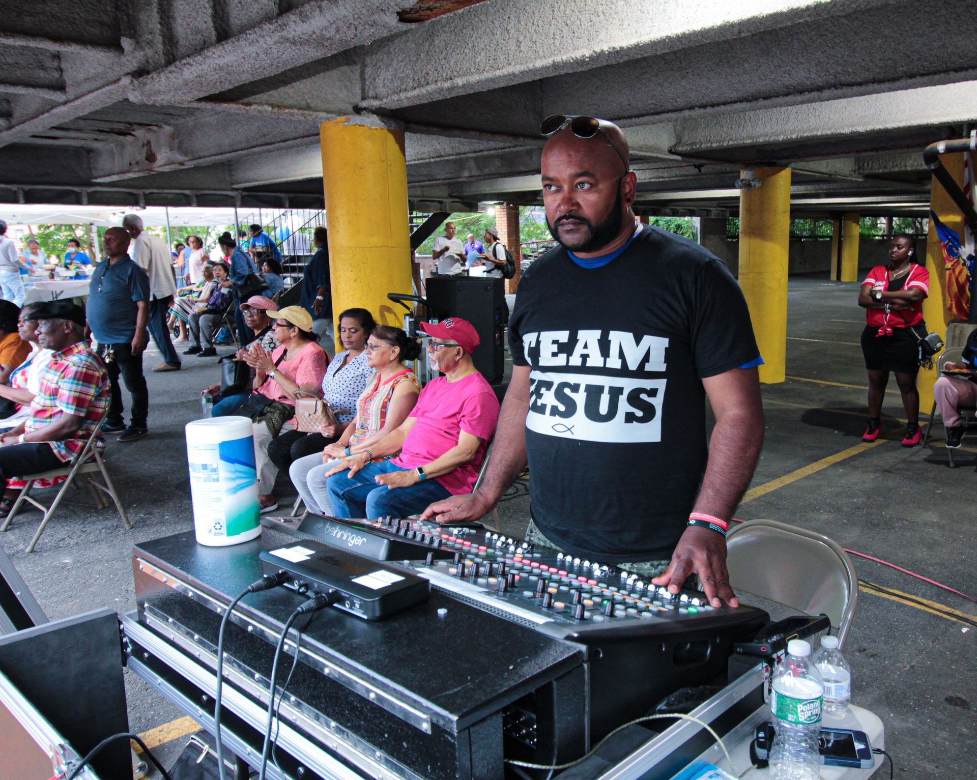 A man wearing a black shirt that says team jesus