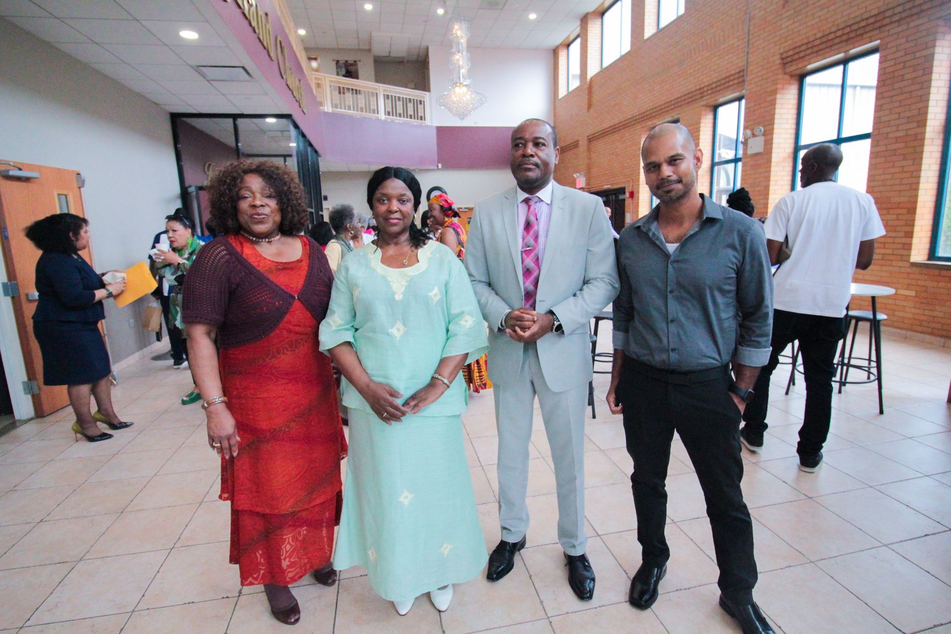 A group of people are posing for a picture in a room.