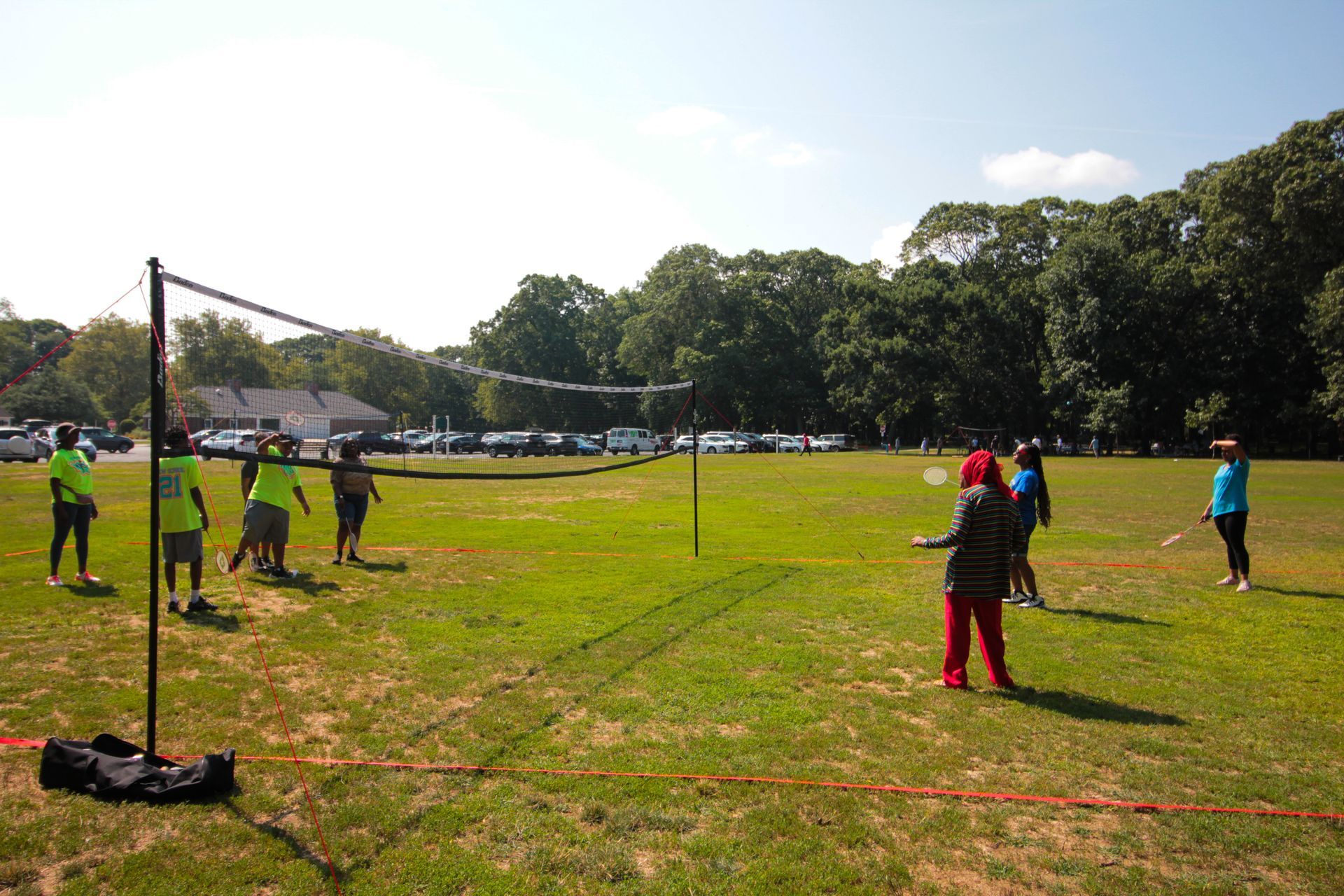 A group of people are playing volleyball in a field
