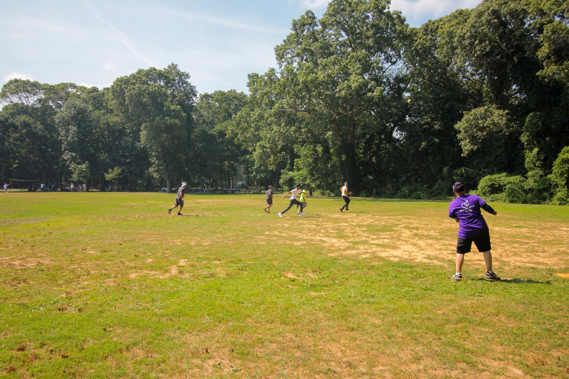 A group of people are playing frisbee in a field