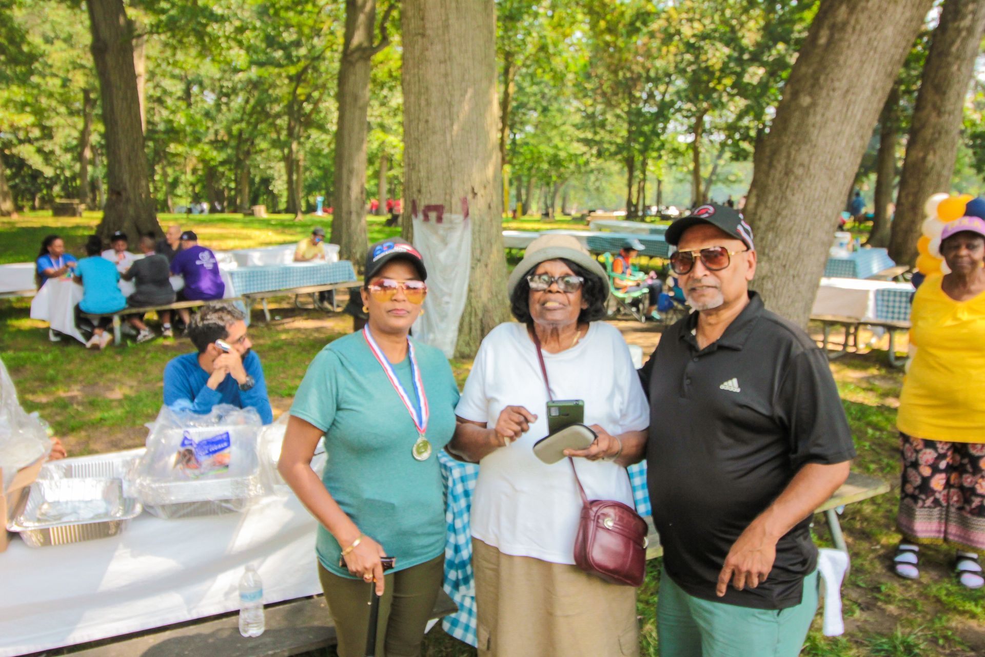 A group of people are posing for a picture in a park.