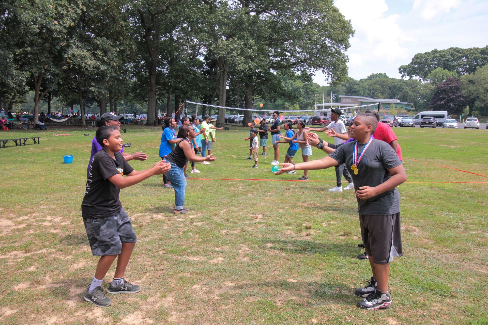 A group of young people are playing a game in a park.