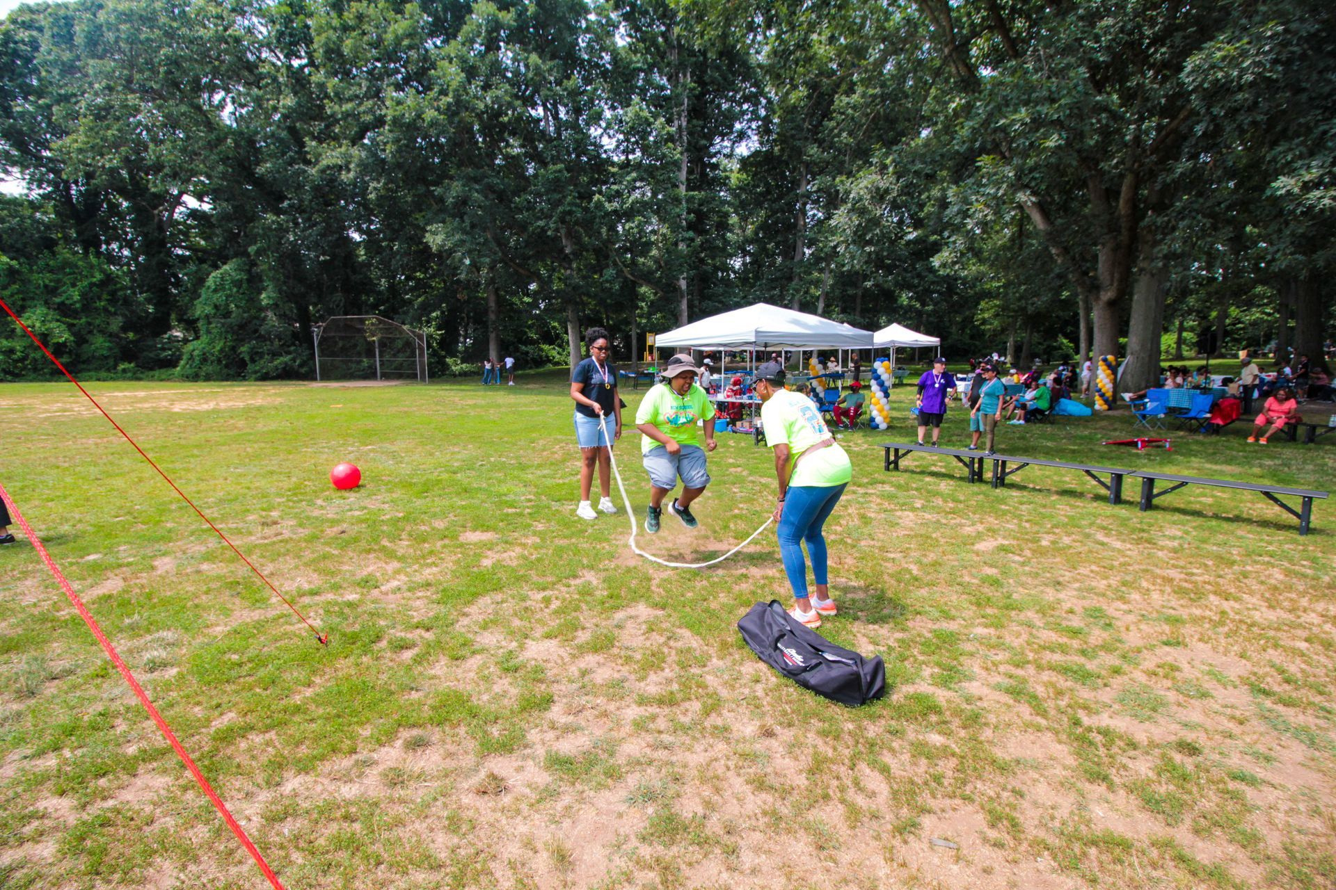 A group of people are playing a game in a park.