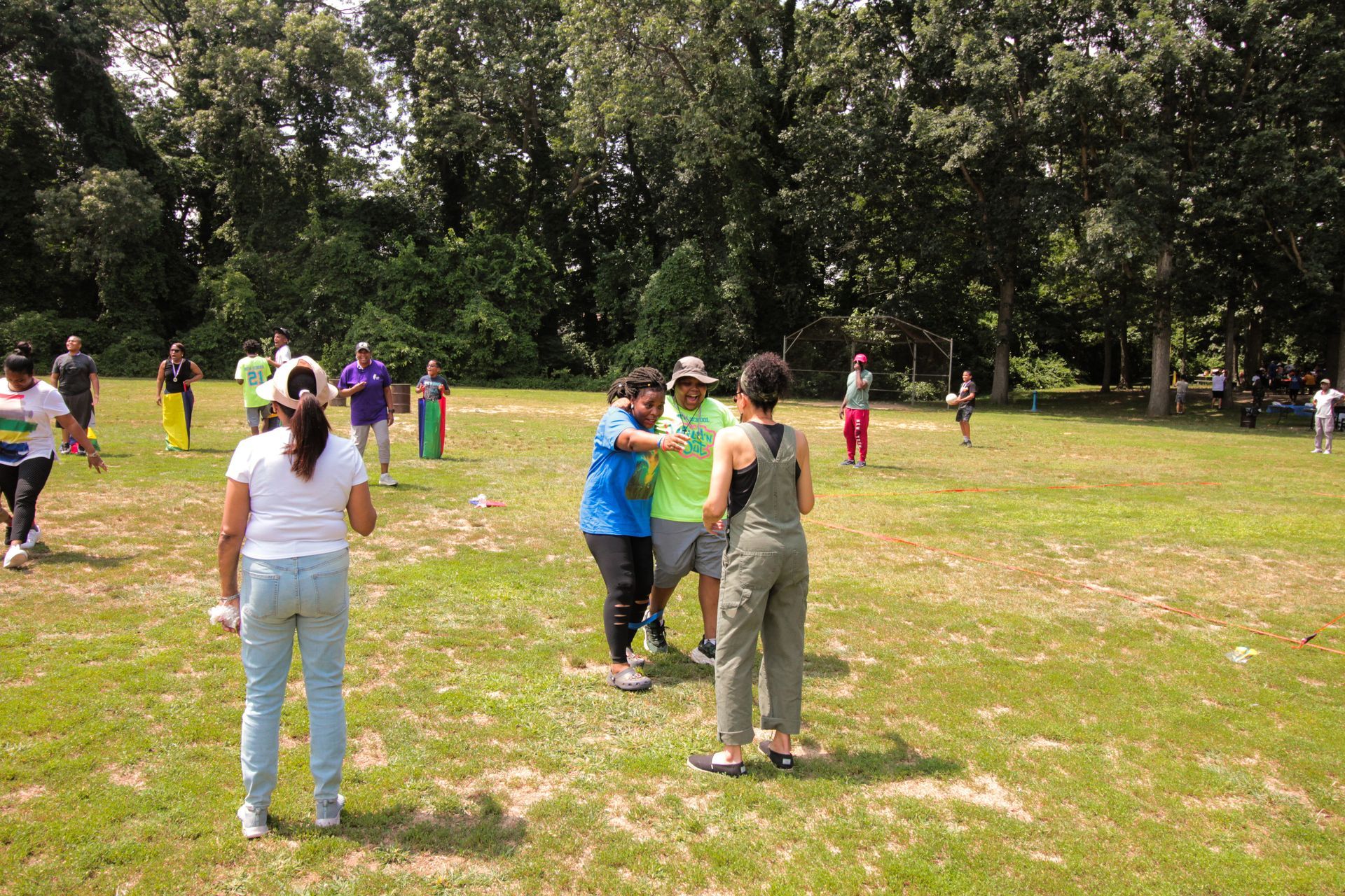 A group of people are standing in a grassy field
