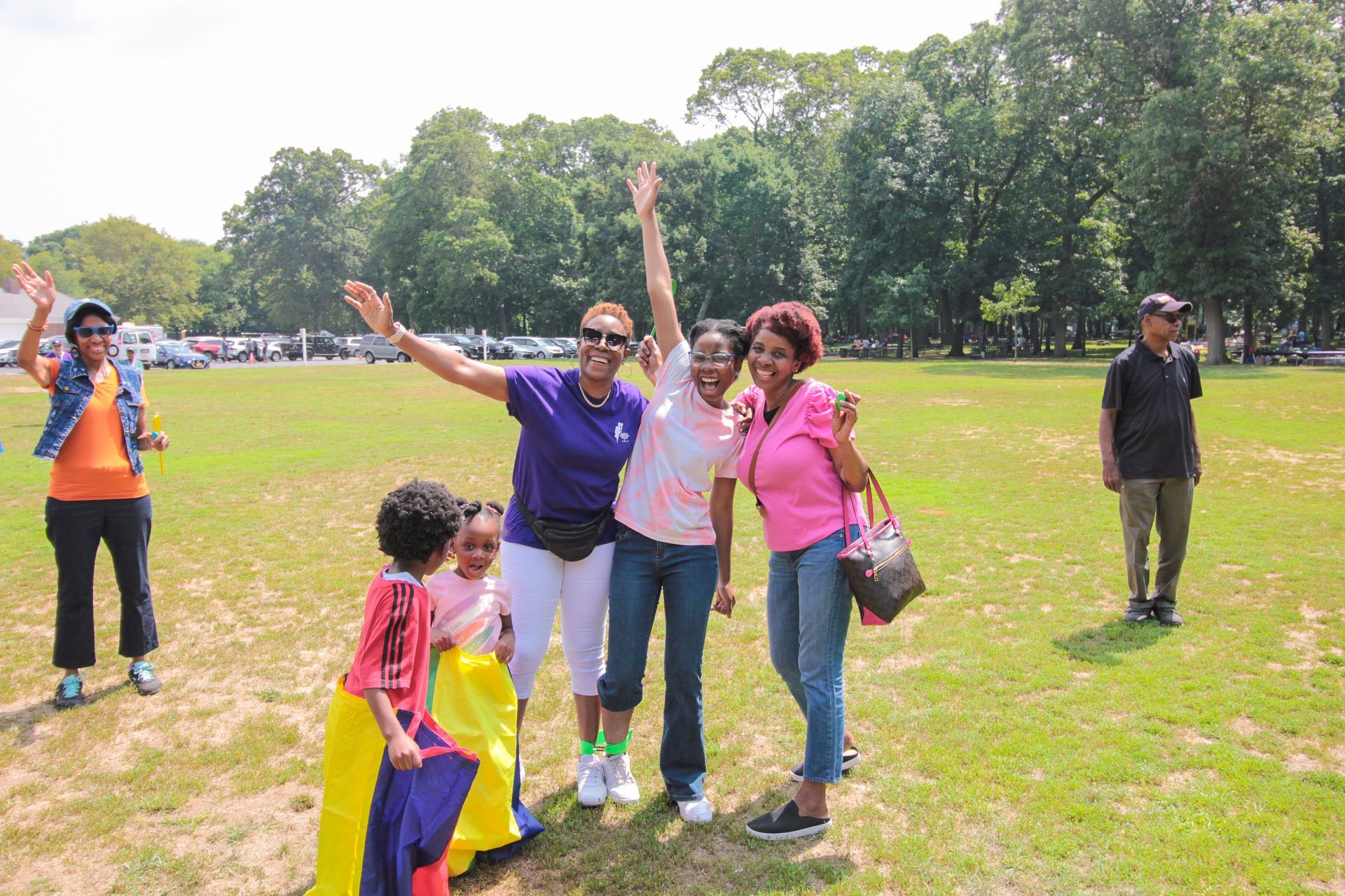 A group of people are posing for a picture in a field.