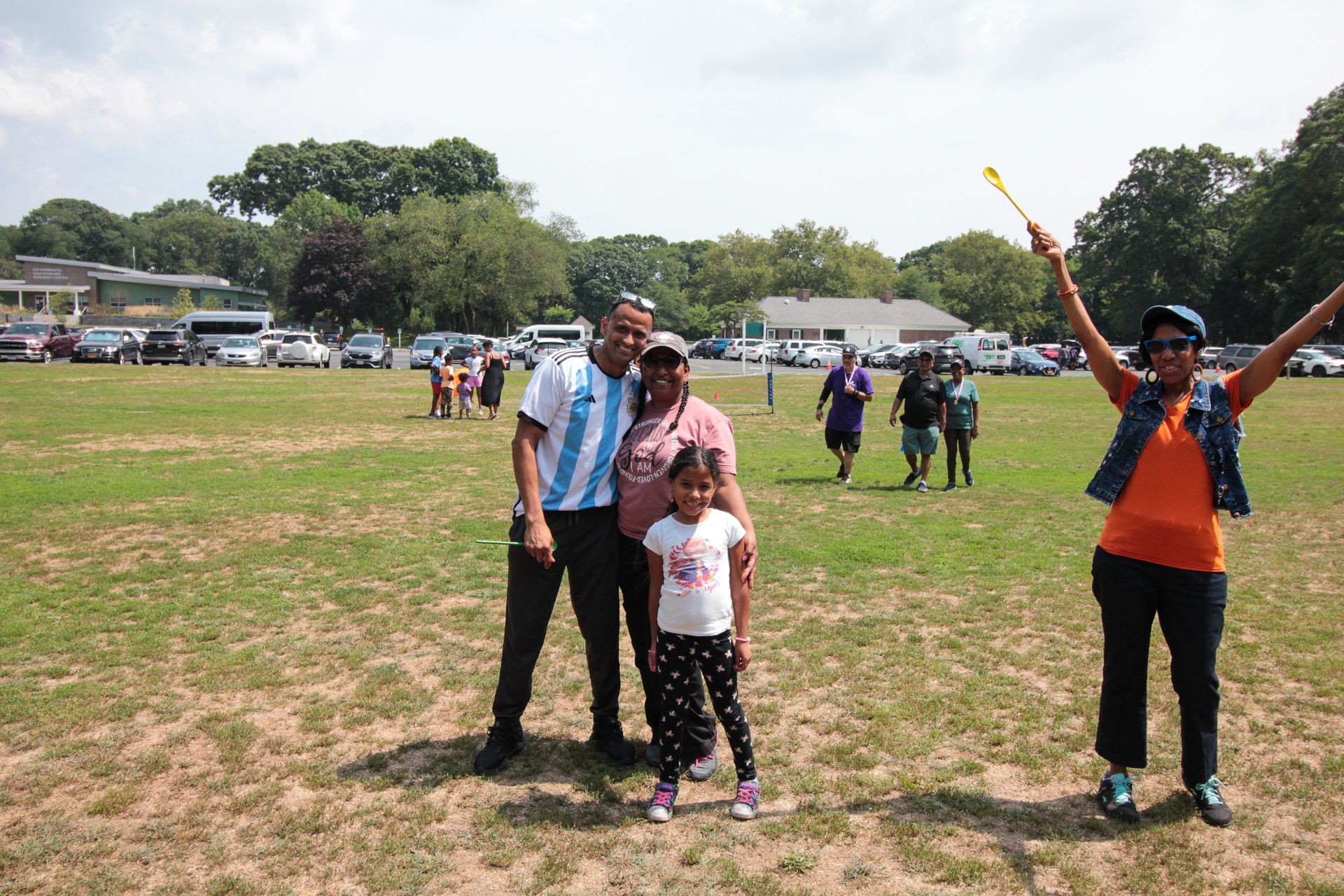 A group of people are posing for a picture in a field.