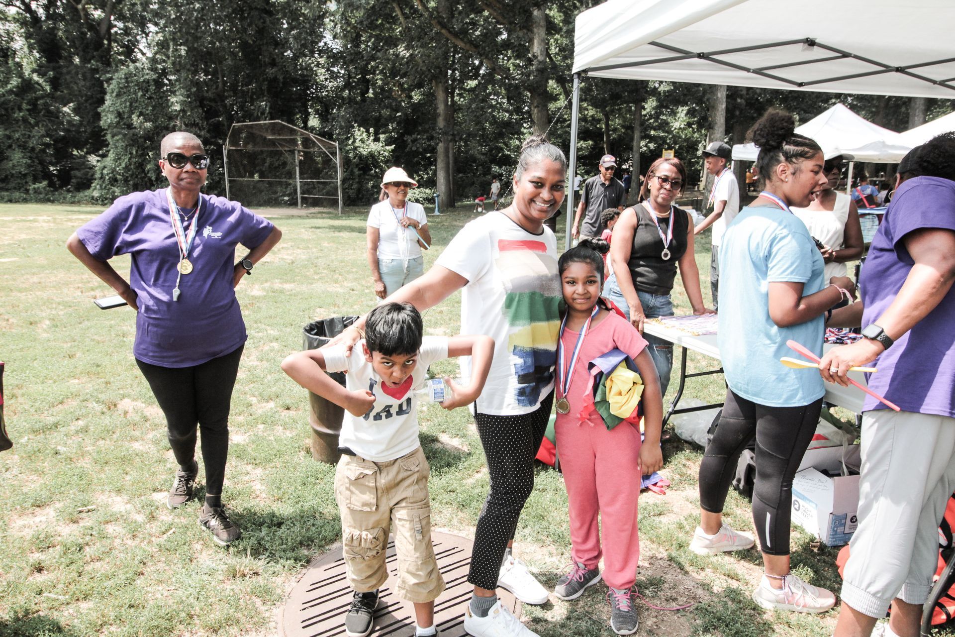 A group of people are standing in a field holding hands.