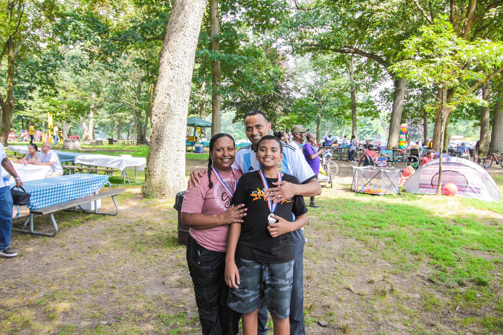 A family is posing for a picture in a park.
