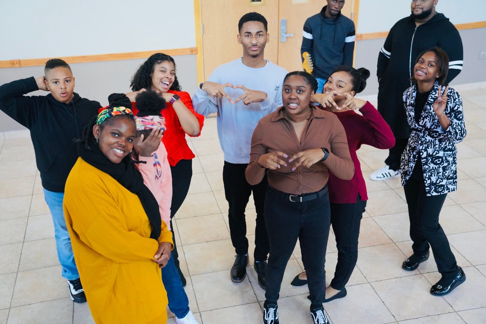 A group of people are posing for a picture in a room.