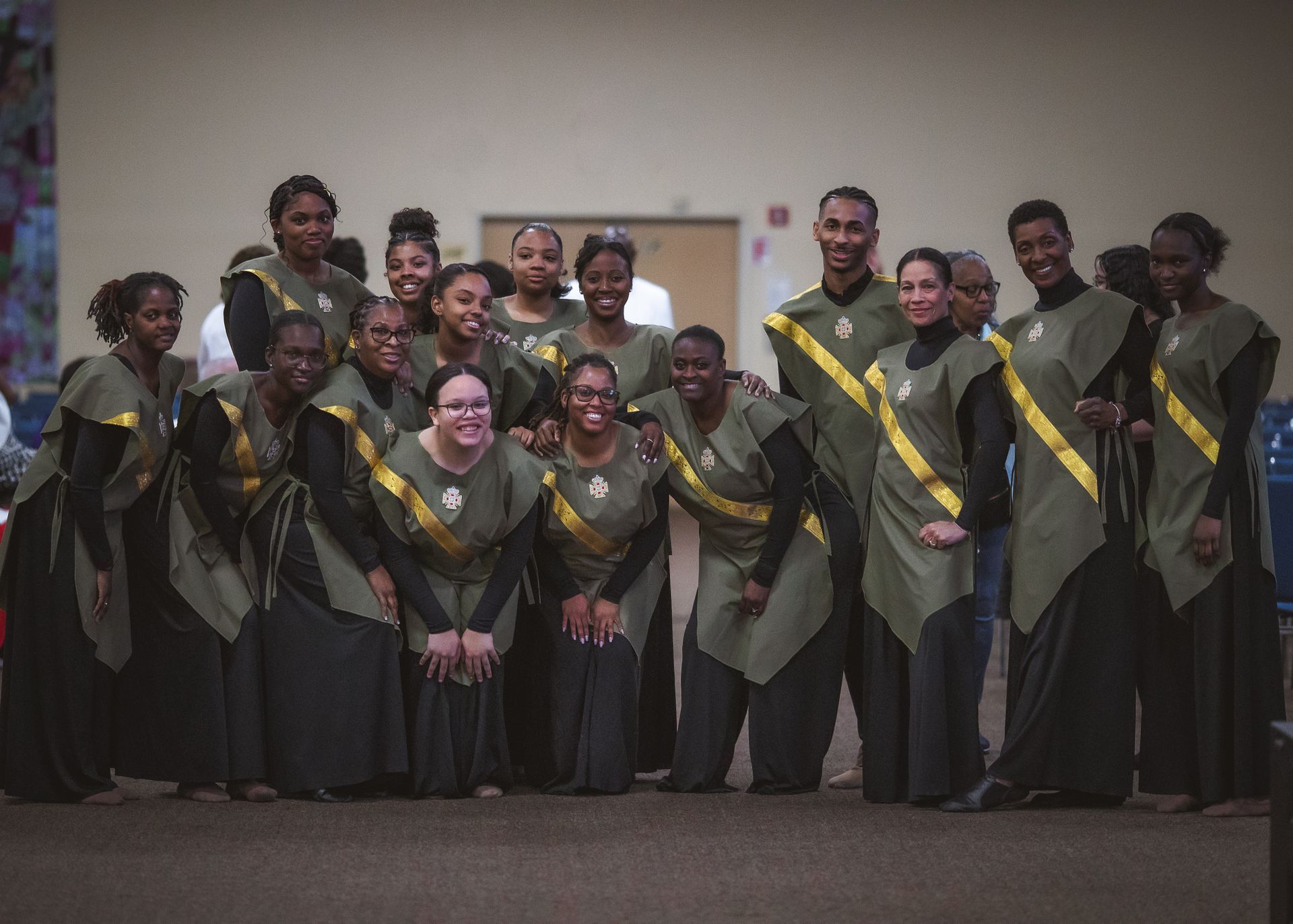 A group of people are posing for a picture in a room.
