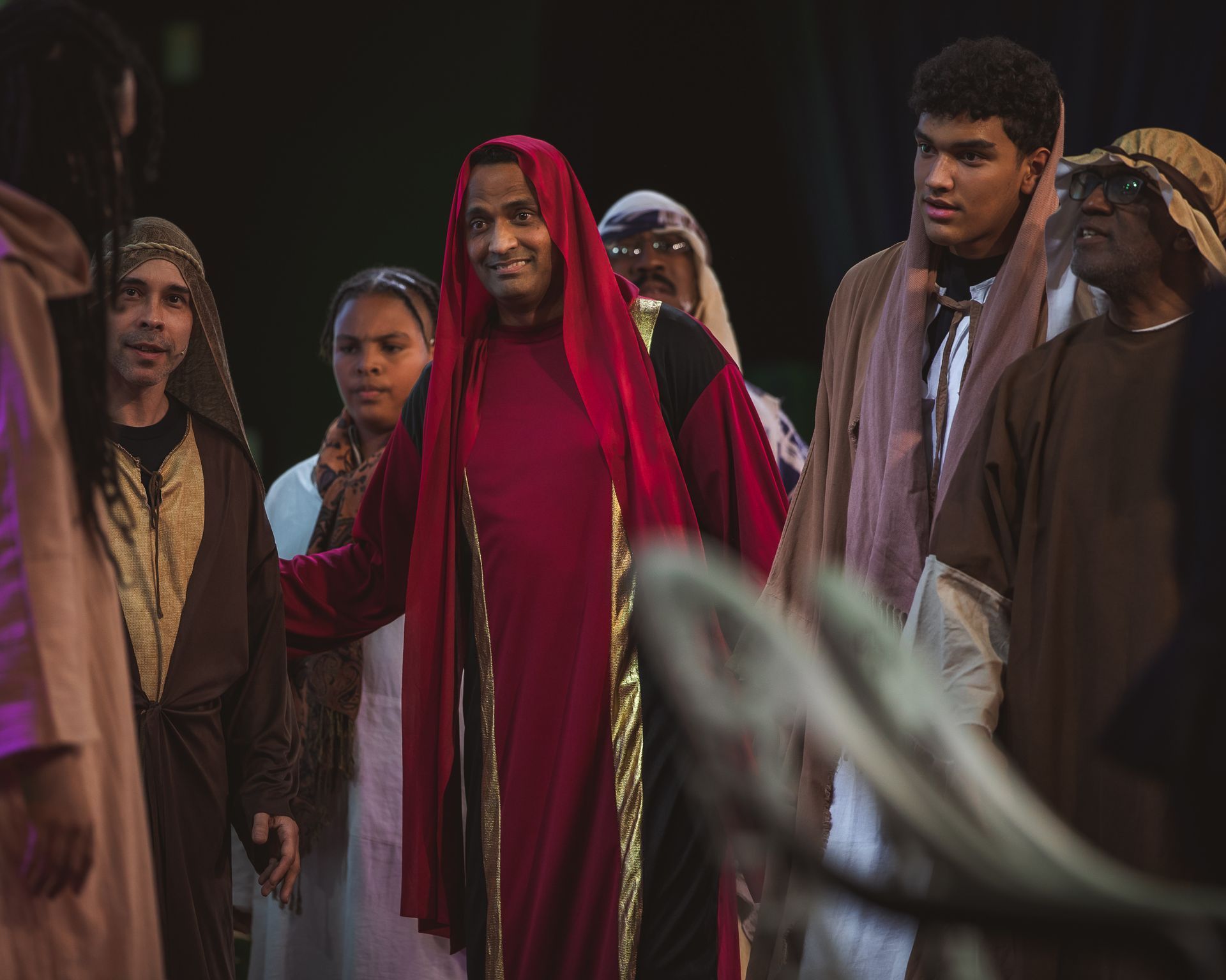 A group of people dressed in costumes are standing together