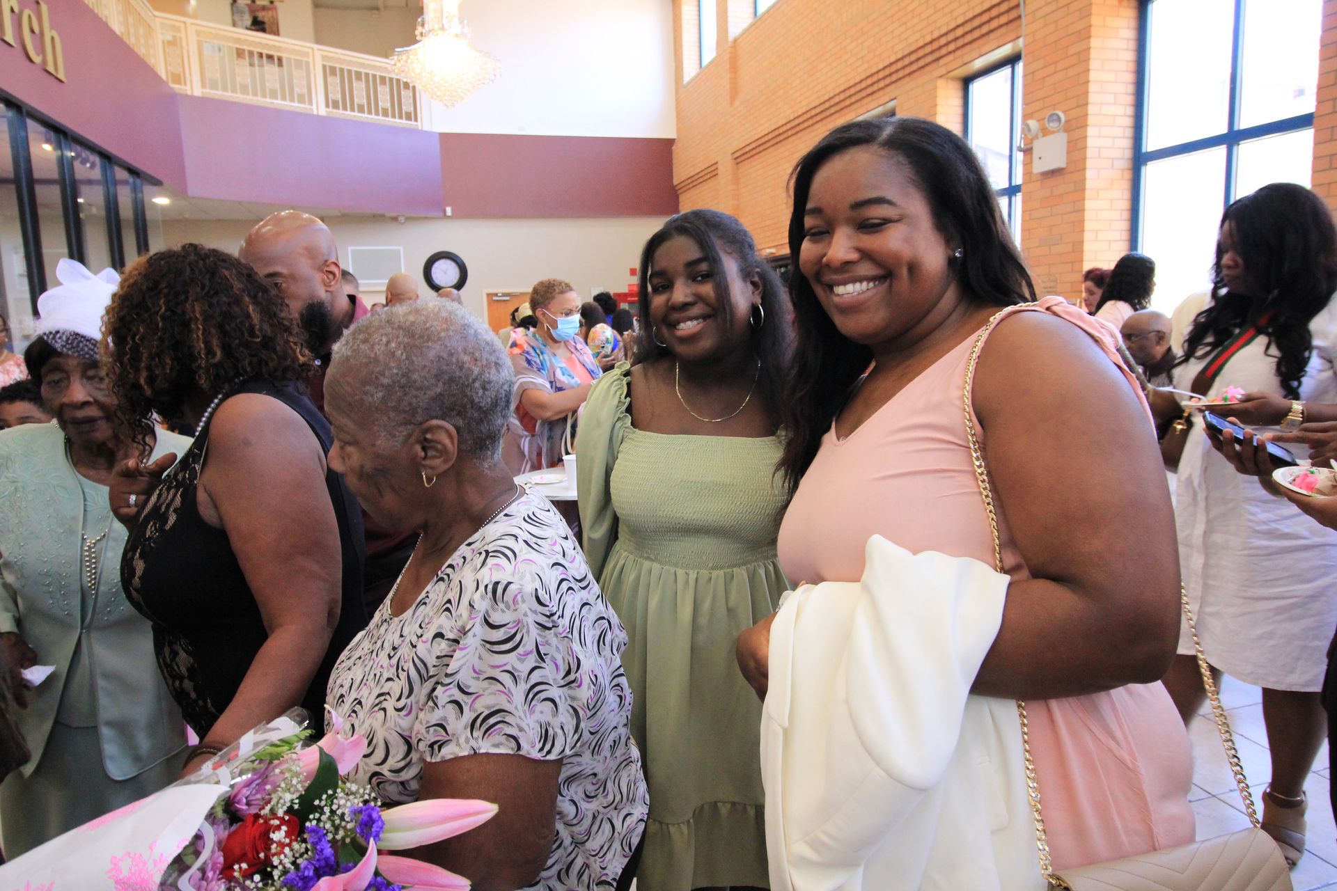 a group of women are posing for a picture in a room .