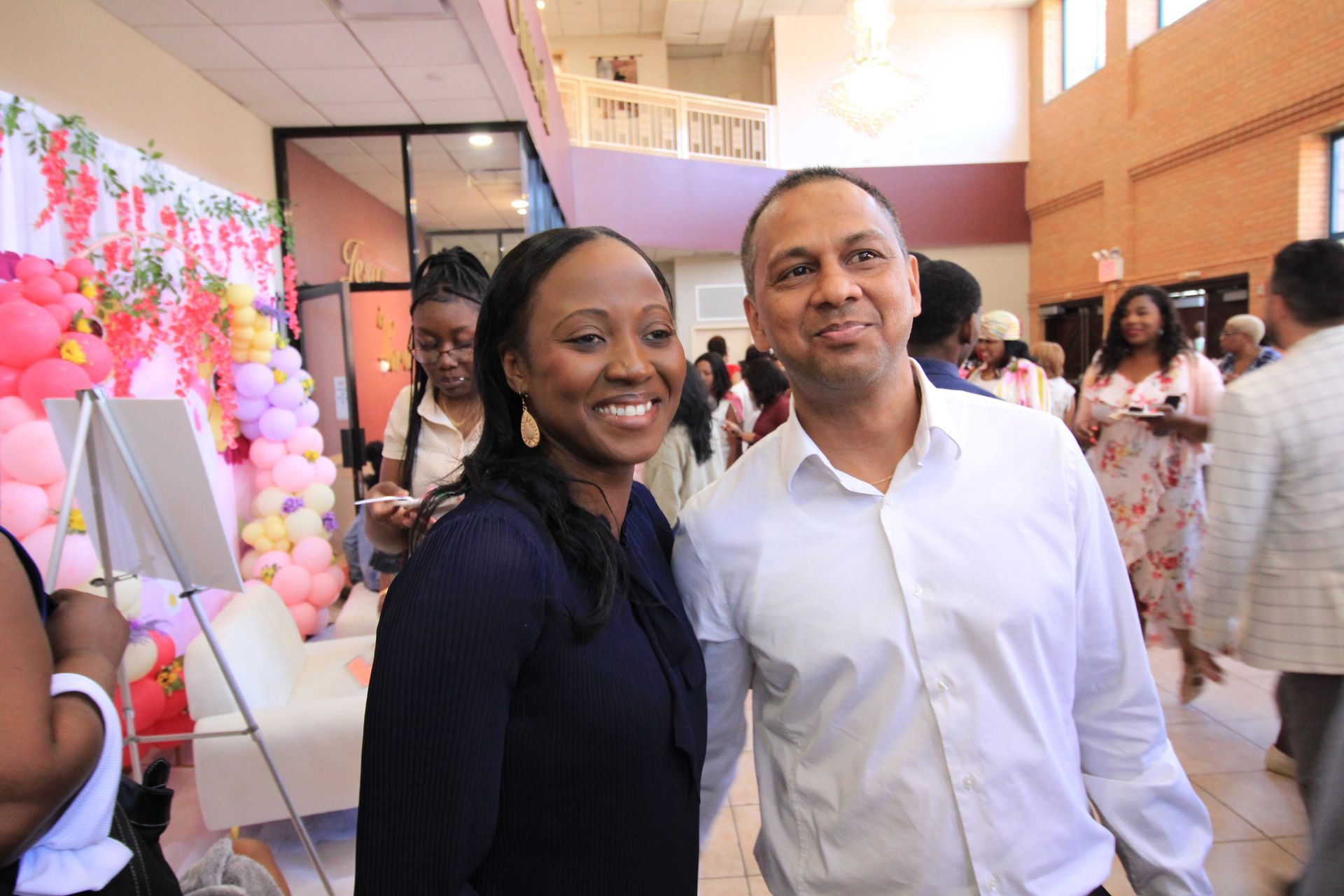a man and a woman are posing for a picture at a party .