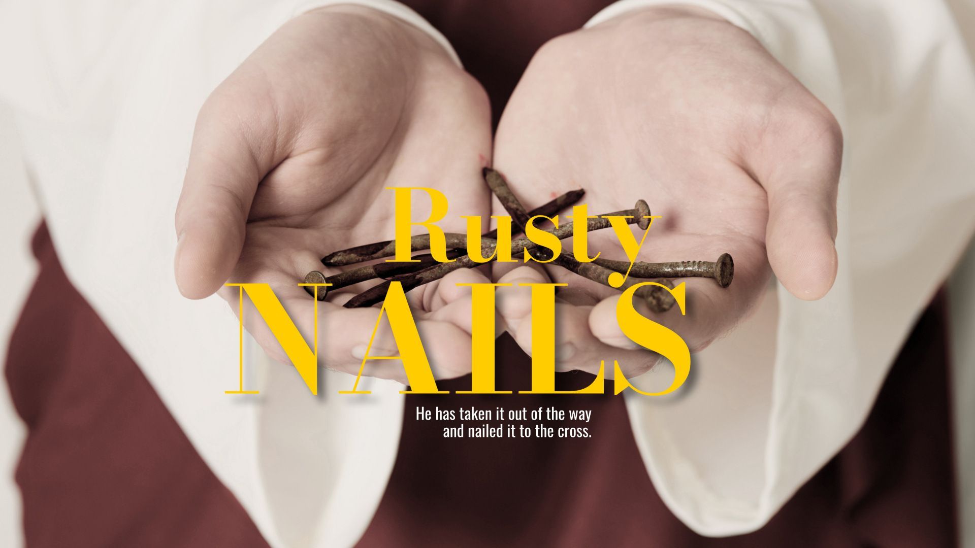 A person is holding rusty nails in their hands