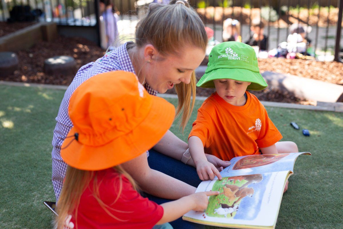 Teacher Reading Books to Children — Moruya Drive Child Care Centre in Port Macquarie, NSW