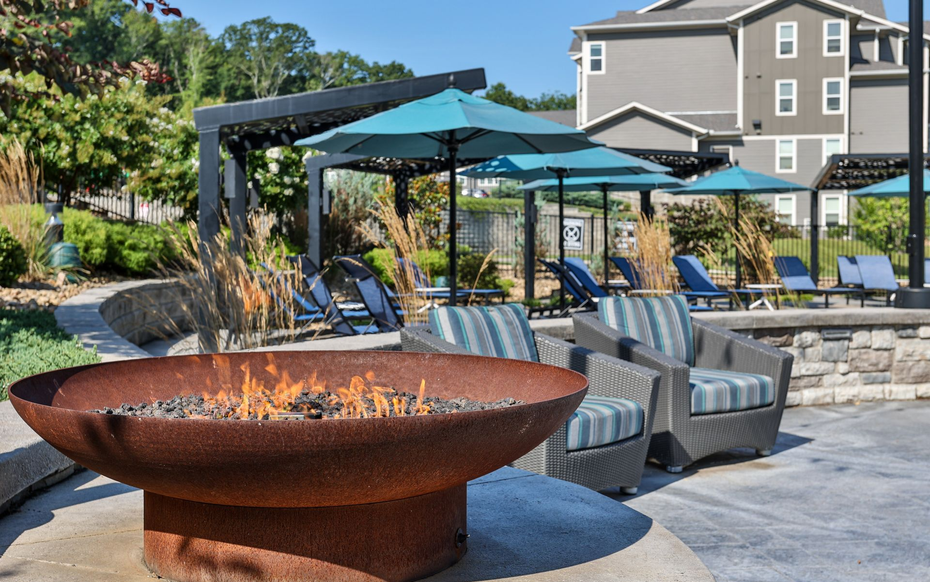 Outdoor patio with dining table, fireplace, and seating.