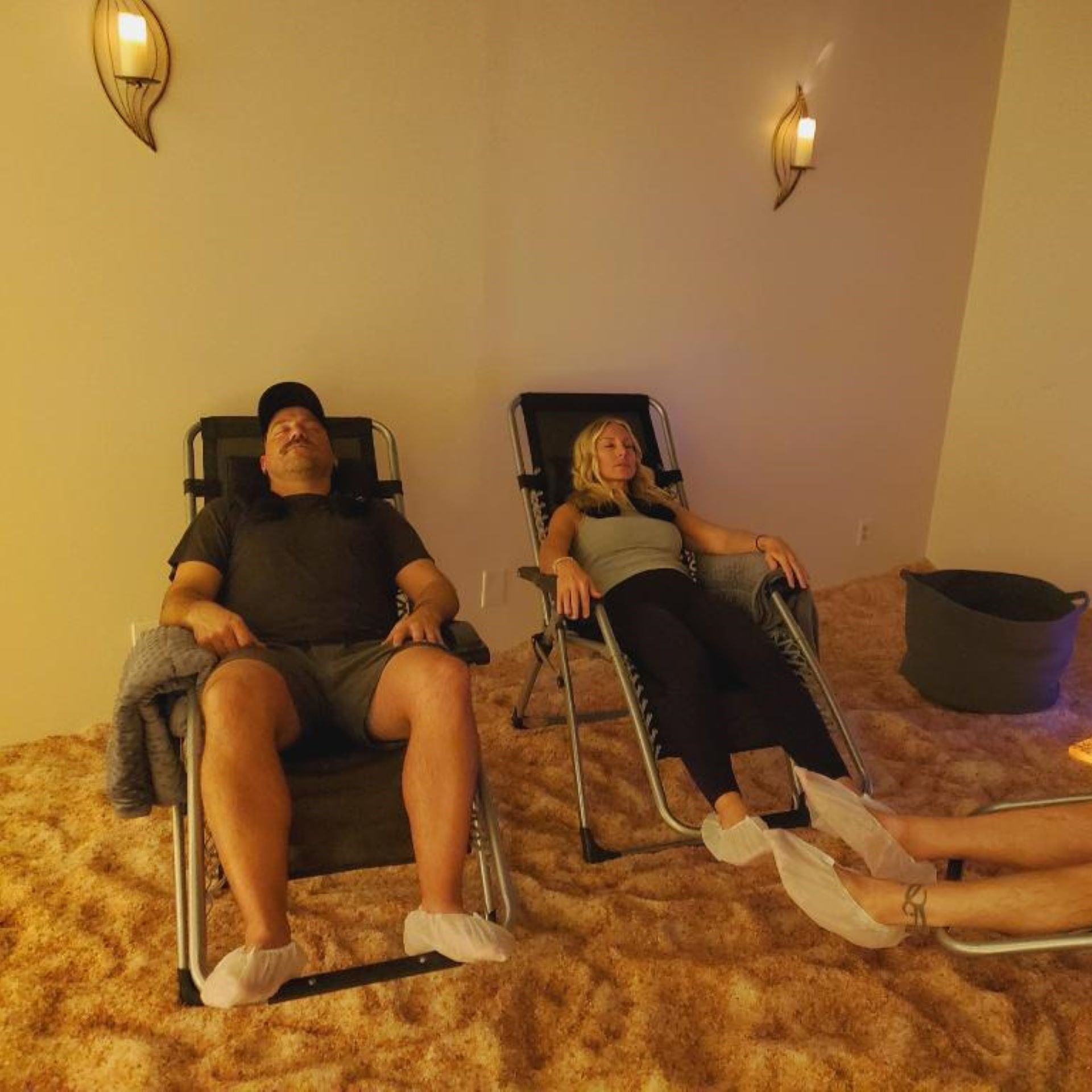 a man and a woman are sitting in chairs in a room