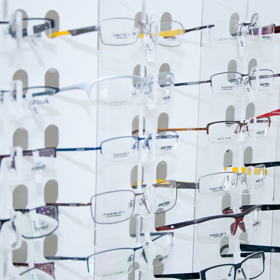 A variety of glasses are displayed on a wall