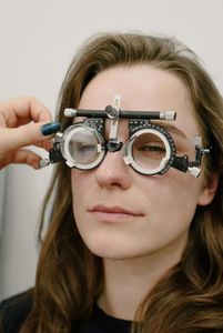 A woman is getting her eyes checked by an ophthalmologist.