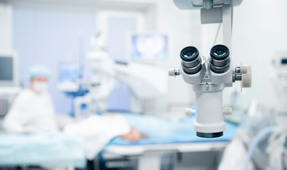 A close up of a microscope in an operating room.