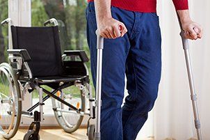 man using crutches to walk