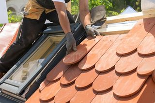 Installing red tile on the roof - Residential Roof Repair in Palm Spring, CA