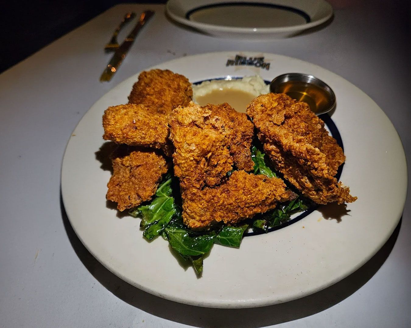 A wide view of a New York bridge stretching across the river, with city skyscrapers