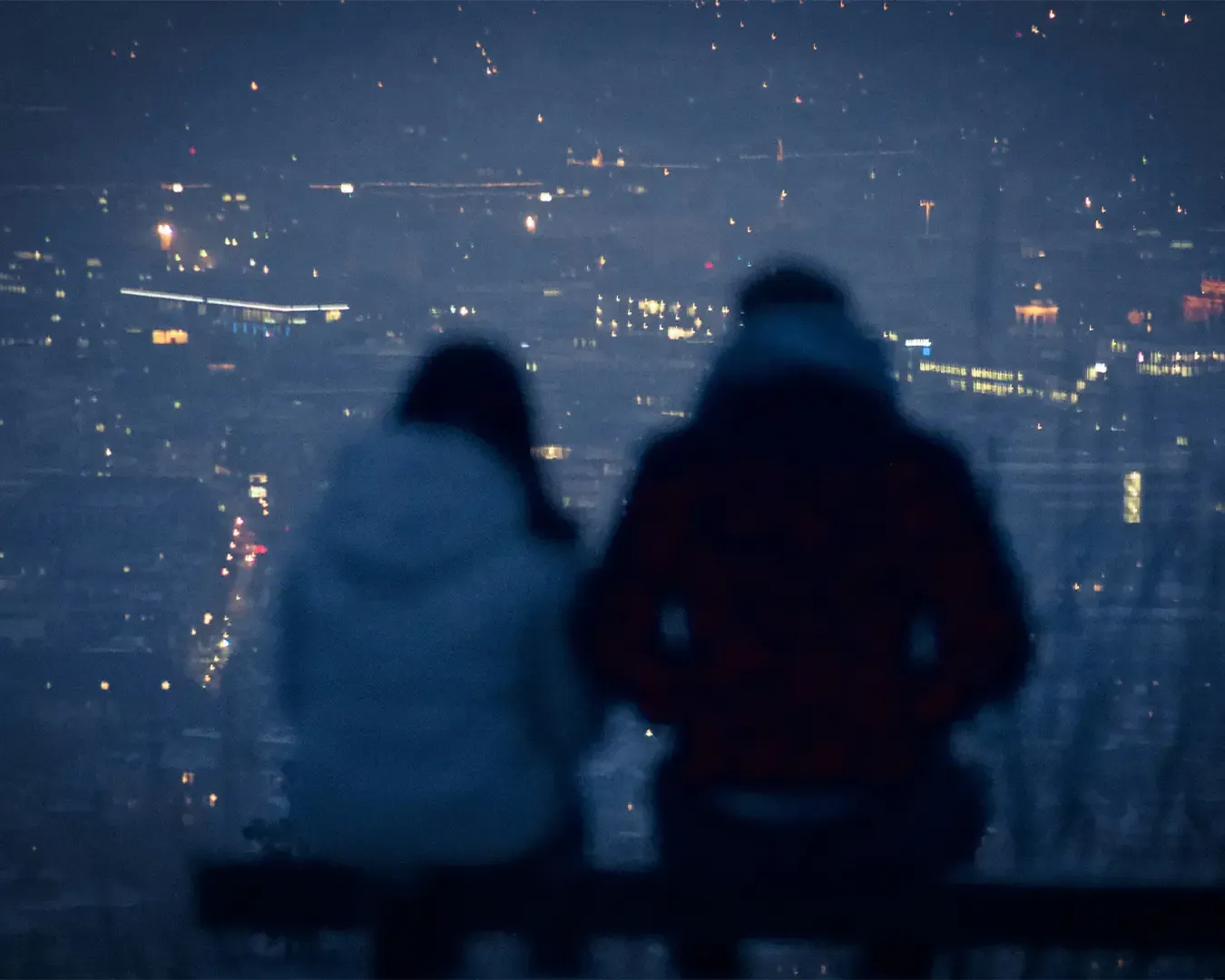 A working setup positioned near a window overlooking a city skyline. The desk area is arranged for productivity, while the view outside adds a sense of openness and inspiration to the workspace.