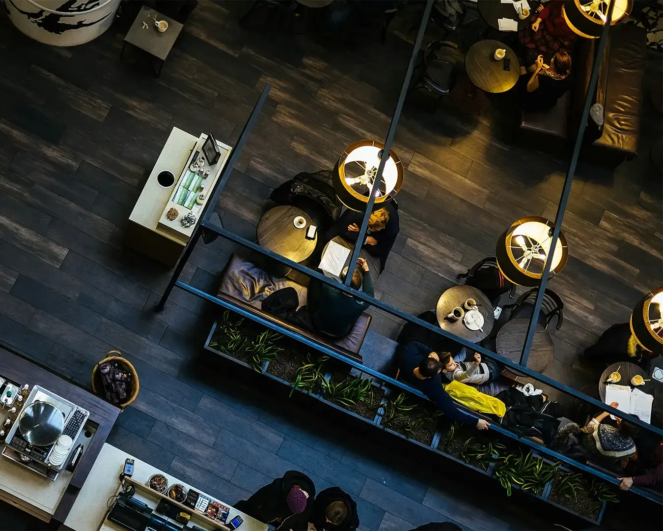 An overhead view of a restaurant space showing the layout of tables and seating, offering a full perspective of the dining environment and ambience.