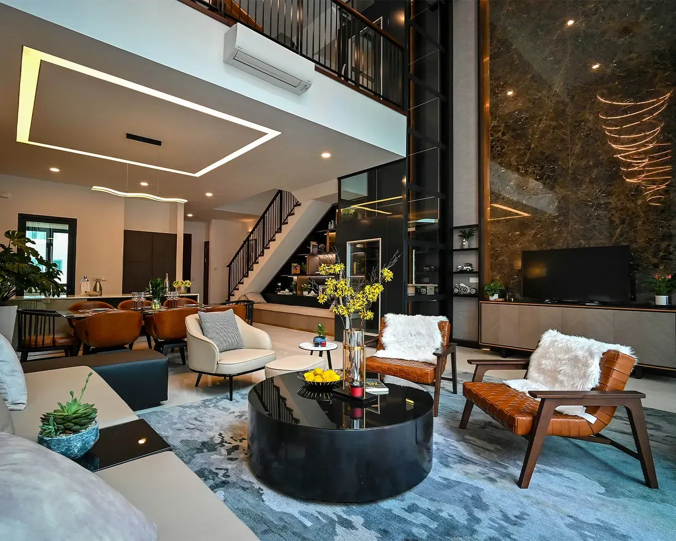 Modern living room with high ceilings, large marble accent wall, stylish furniture, and a sleek black coffee table. Warm, inviting ambiance.