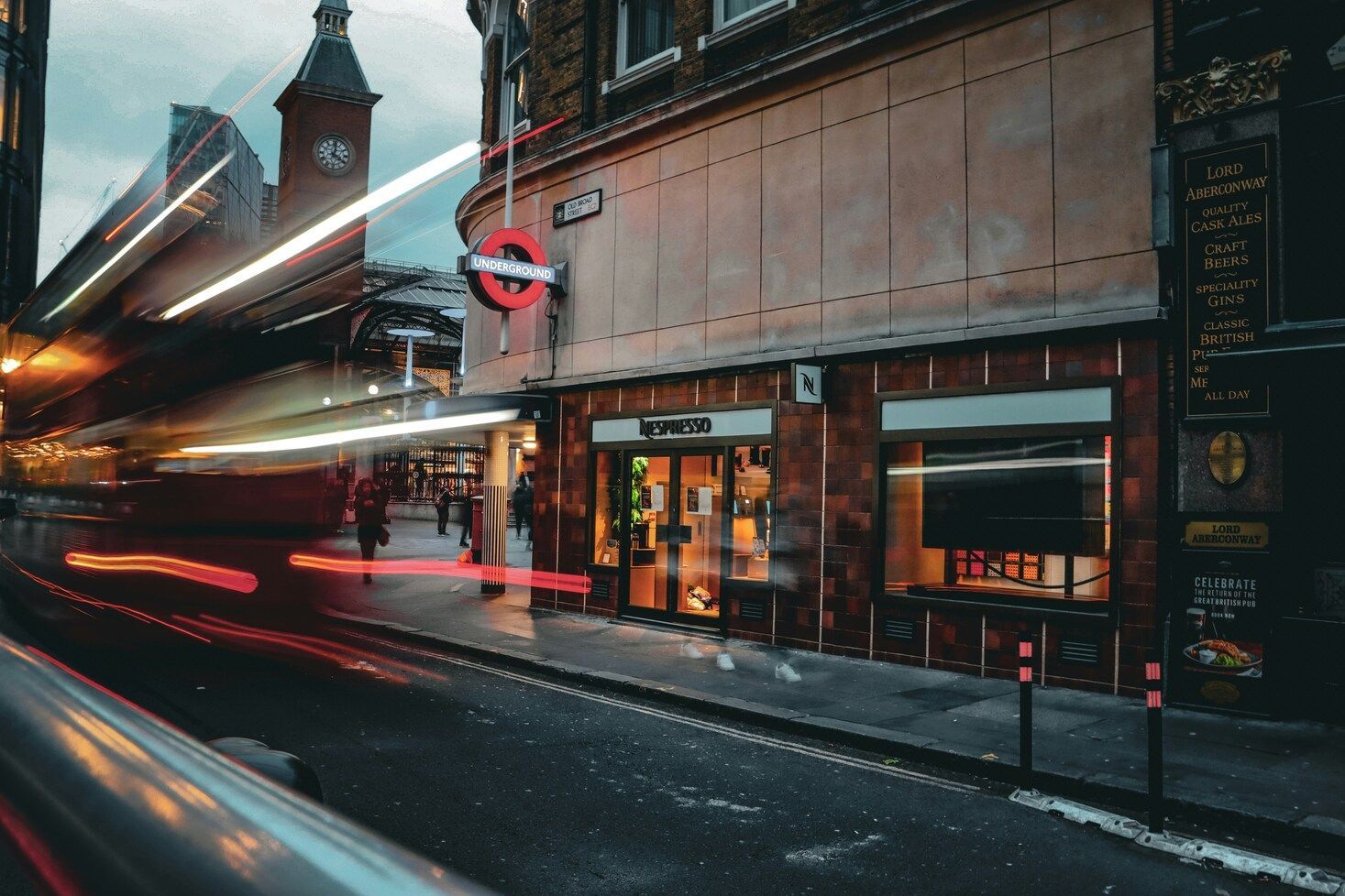 Travelling Assistant : A moving bus framed against city lights, representing constant movement and exploration.