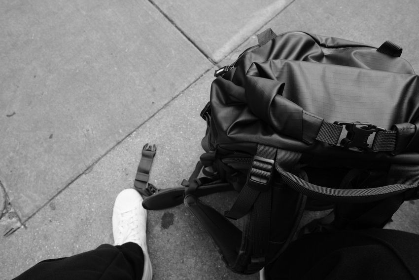 Travelling Assistant : A traveller walking with a backpack into the horizon.