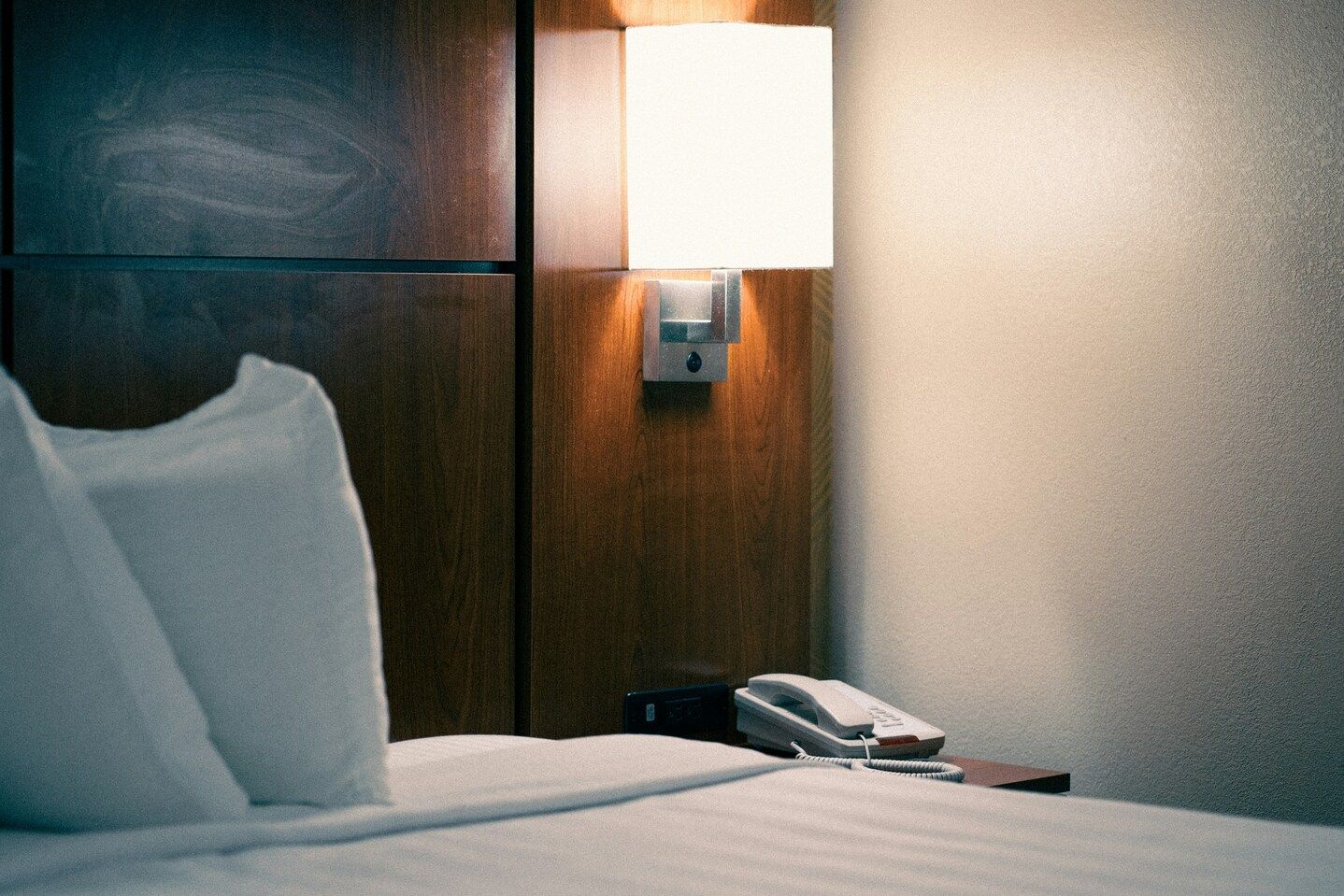 The Midnight Concierge : Quiet hotel moment capturing a phone by the bed, symbolising comfort and convenience