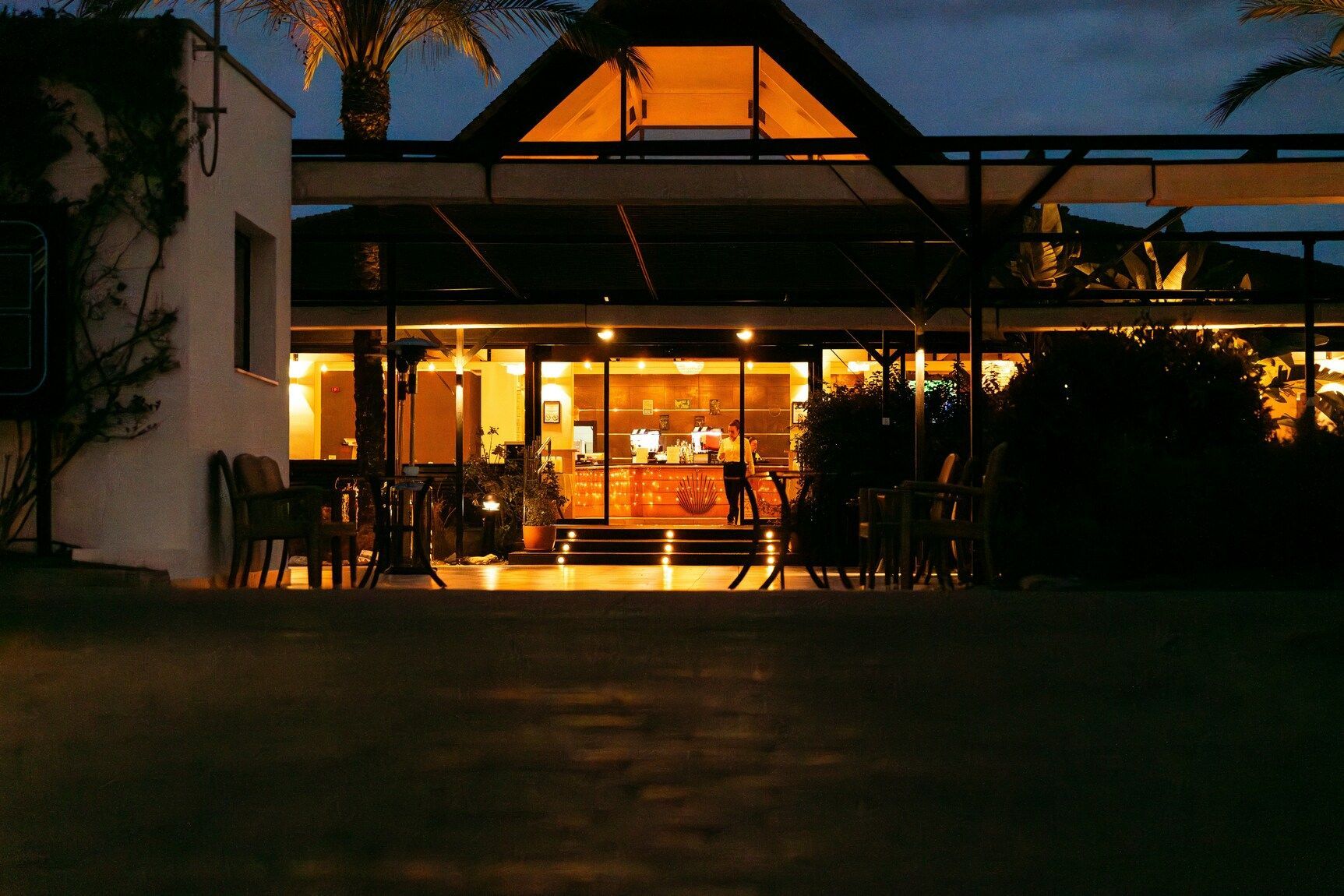 The Midnight Concierge : Hotel lobby glowing softly at night as a concierge assists a late-night guest.