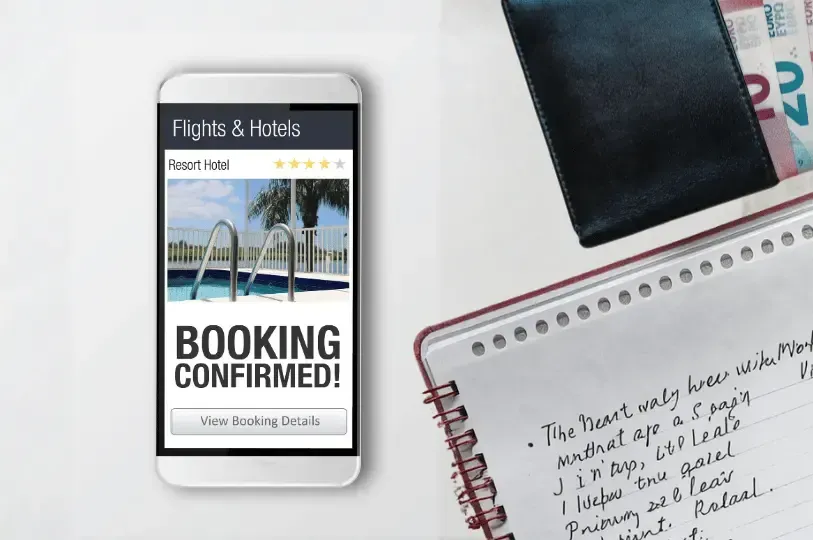 A close-up view of a smartphone and a wallet laid out together, illustrating the careful itinerary planning, organization, and preparation that goes into a well-managed trip.