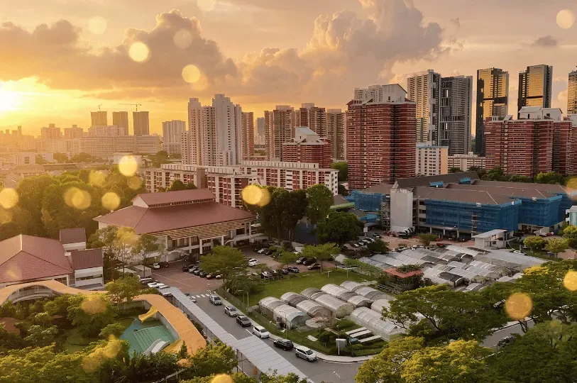A scenic golden hour view overlooking a residential Singaporean neighborhood, featuring low-rise com
