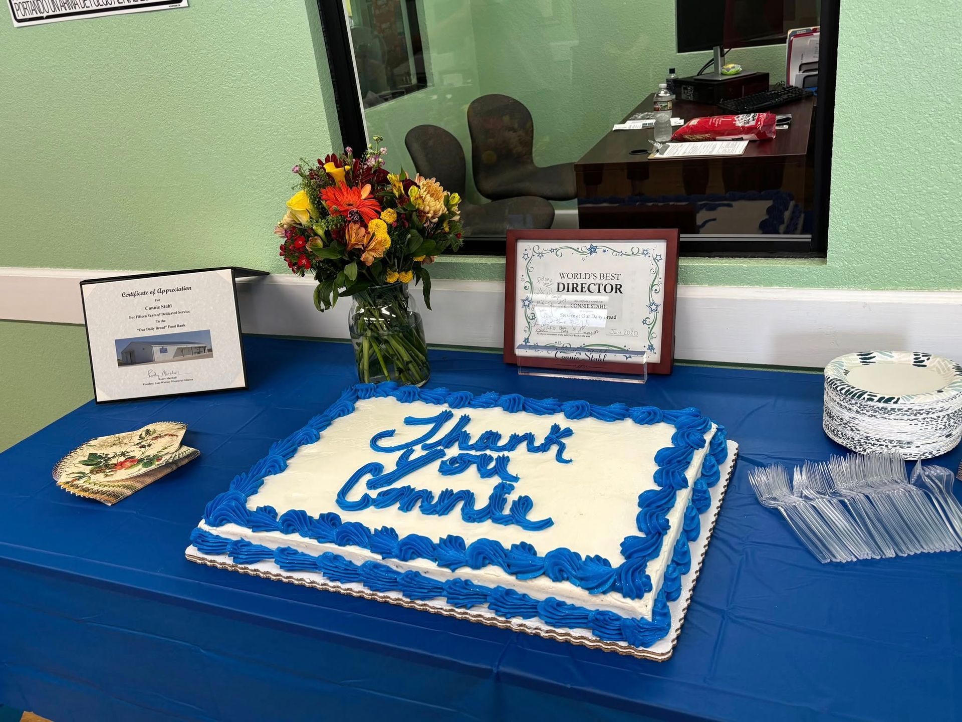 A sheet cake with blue frosting says 