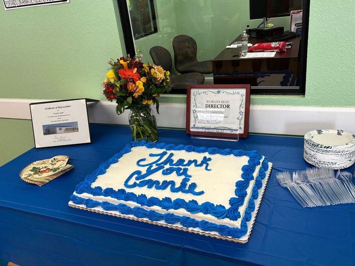 A sheet cake with blue frosting says 