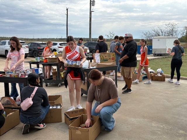 A man is standing in front of a refrigerator filled with bags of food.
