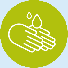 Hands being washed, with water droplets, in a green circle.
