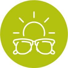 Sunglasses in front of sunburst in green circle.