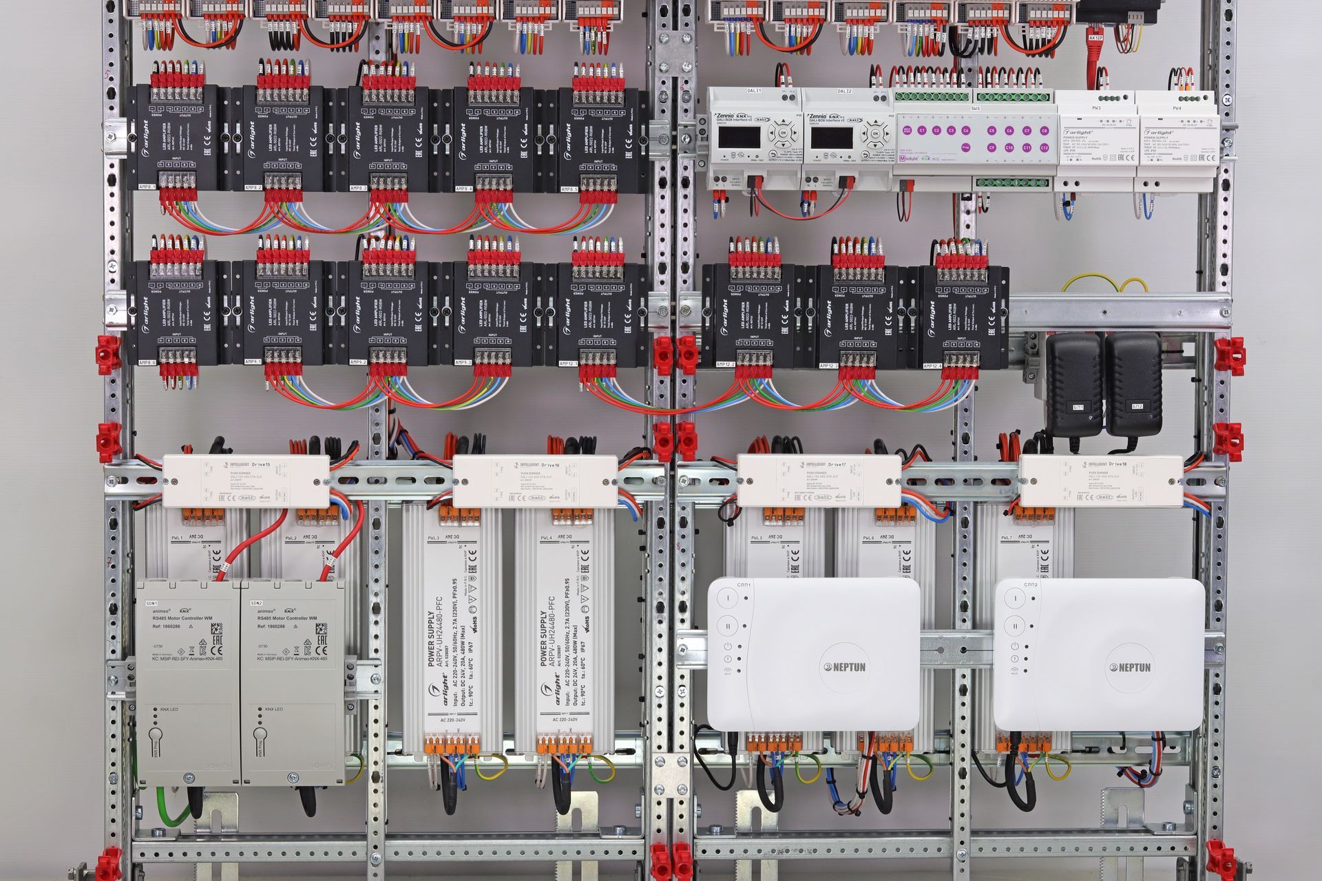 Woman in straw hat smiles, holding wine glass near a lake.