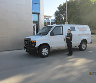 Security guard standing by van - security services in Bismarck, ND