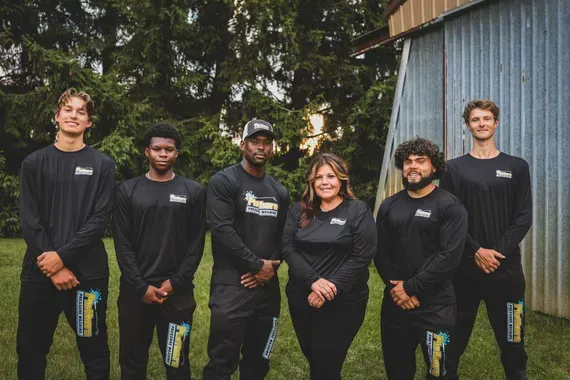 A group of people standing next to each other in front of a building.