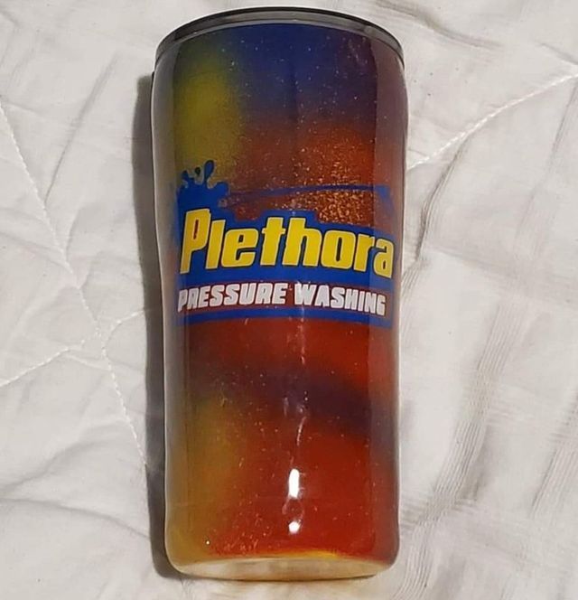 A rainbow colored tumbler with the words piethora pressure washing on it