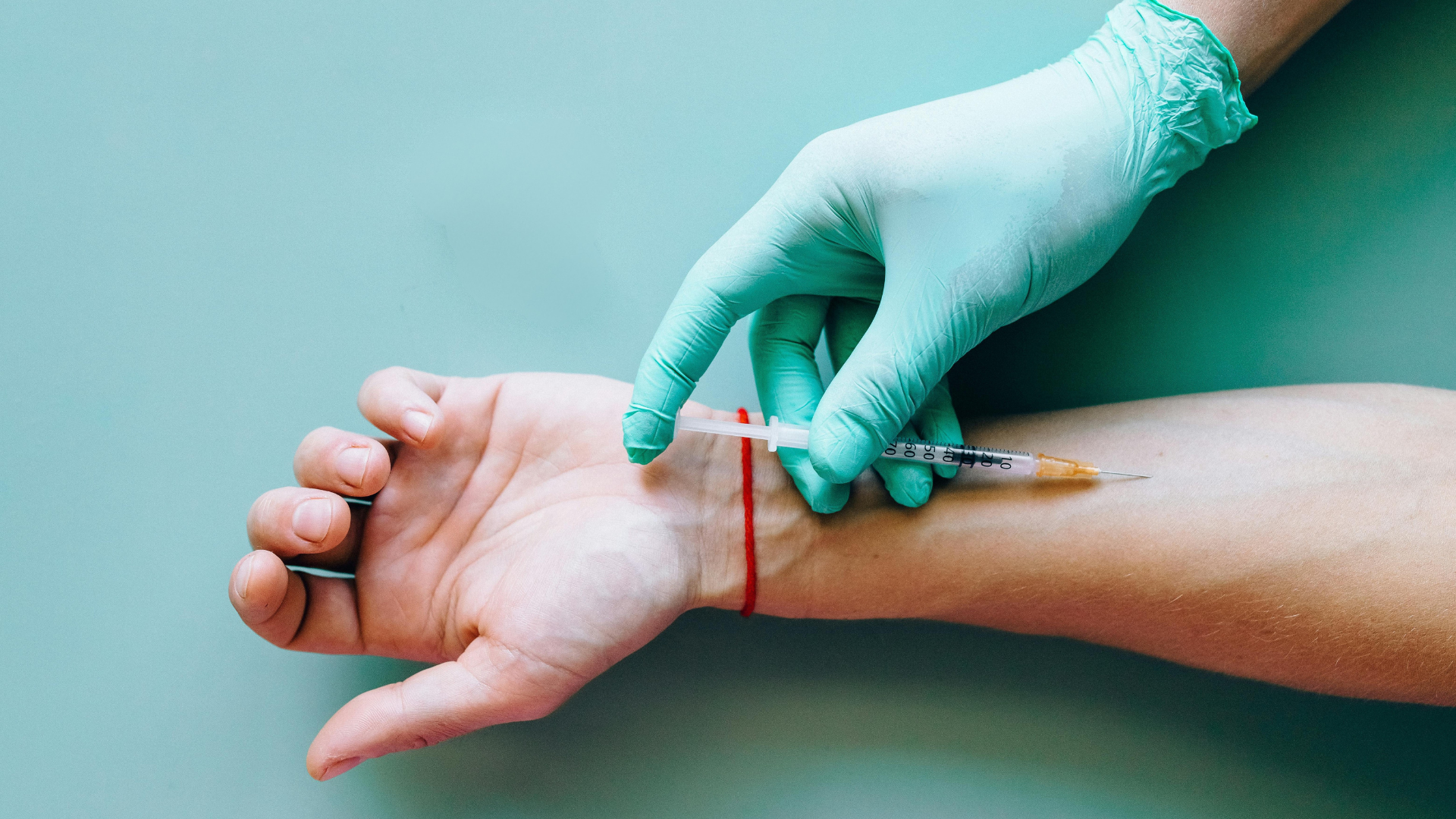 A person is getting an injection in their arm.